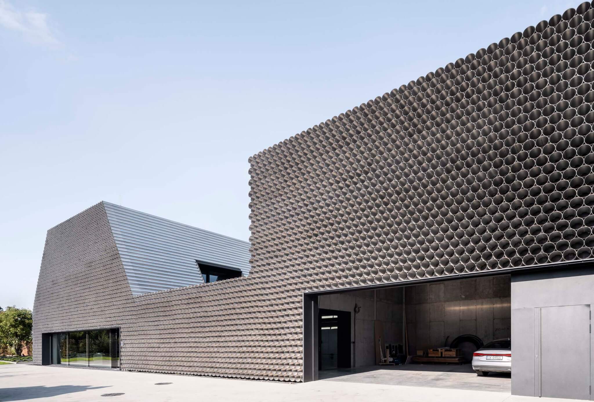 KWK Promes designs a Polish pipe distribution facility to look like a stack of aluminum tubes