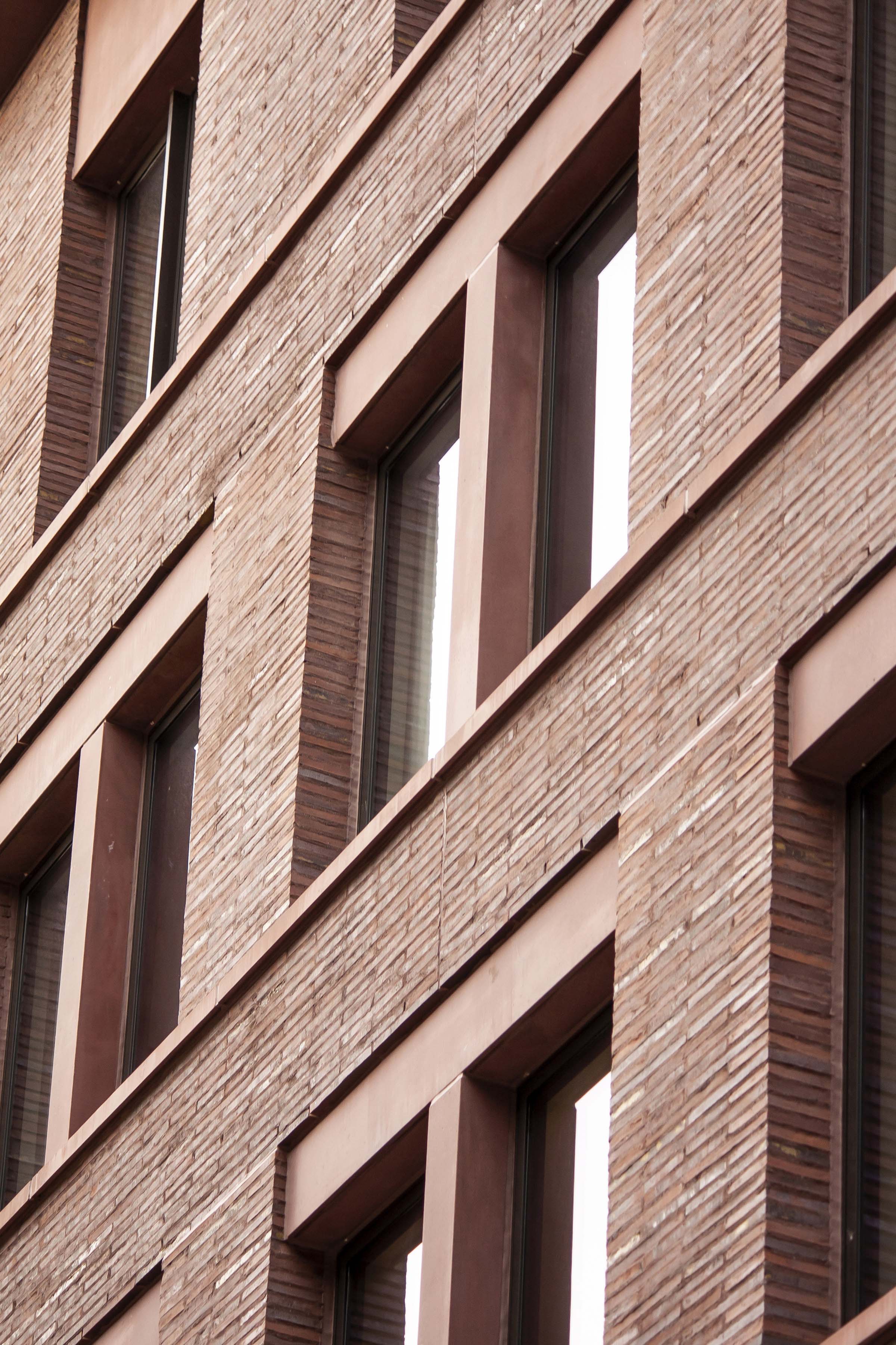 detail photo of the facade shows the handmade bricks flush with the lintels and window casings at 11-19 Jane Street