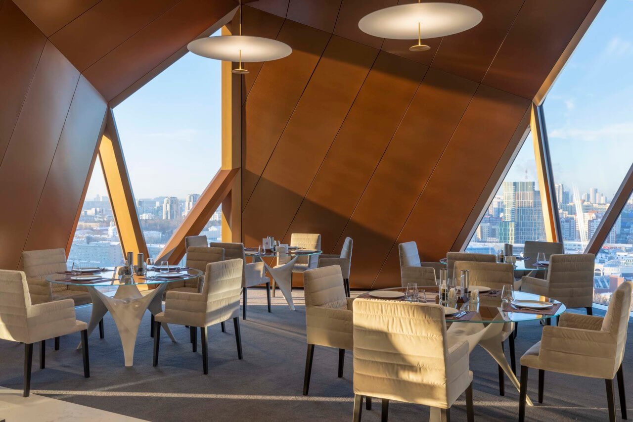 double height dining space shows off the furniture foster + partners designed for the client