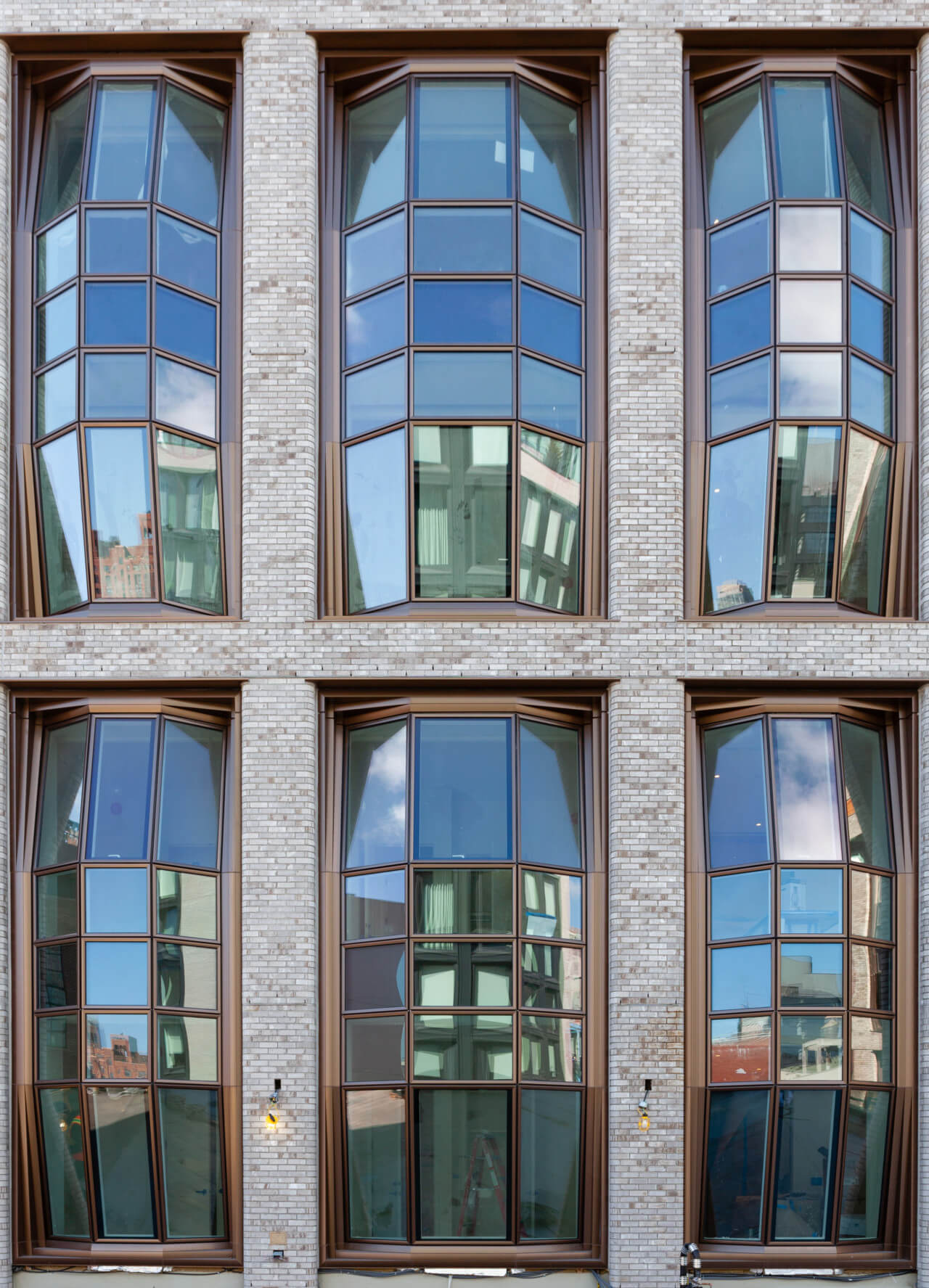 exterior photograph of a contemporary New York luxury residential building with large bay windows
