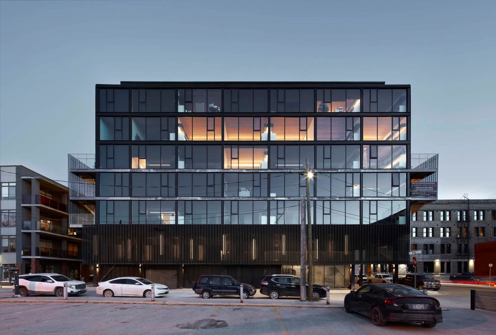 5468796 Architecture renovates a historic pumphouse in Winnipeg, adding a pair of apartment buildings clad in corrugated metal