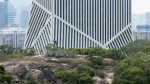 OMA’s JOMOO Headquarters flexes white ceramic stripes angled in different directions