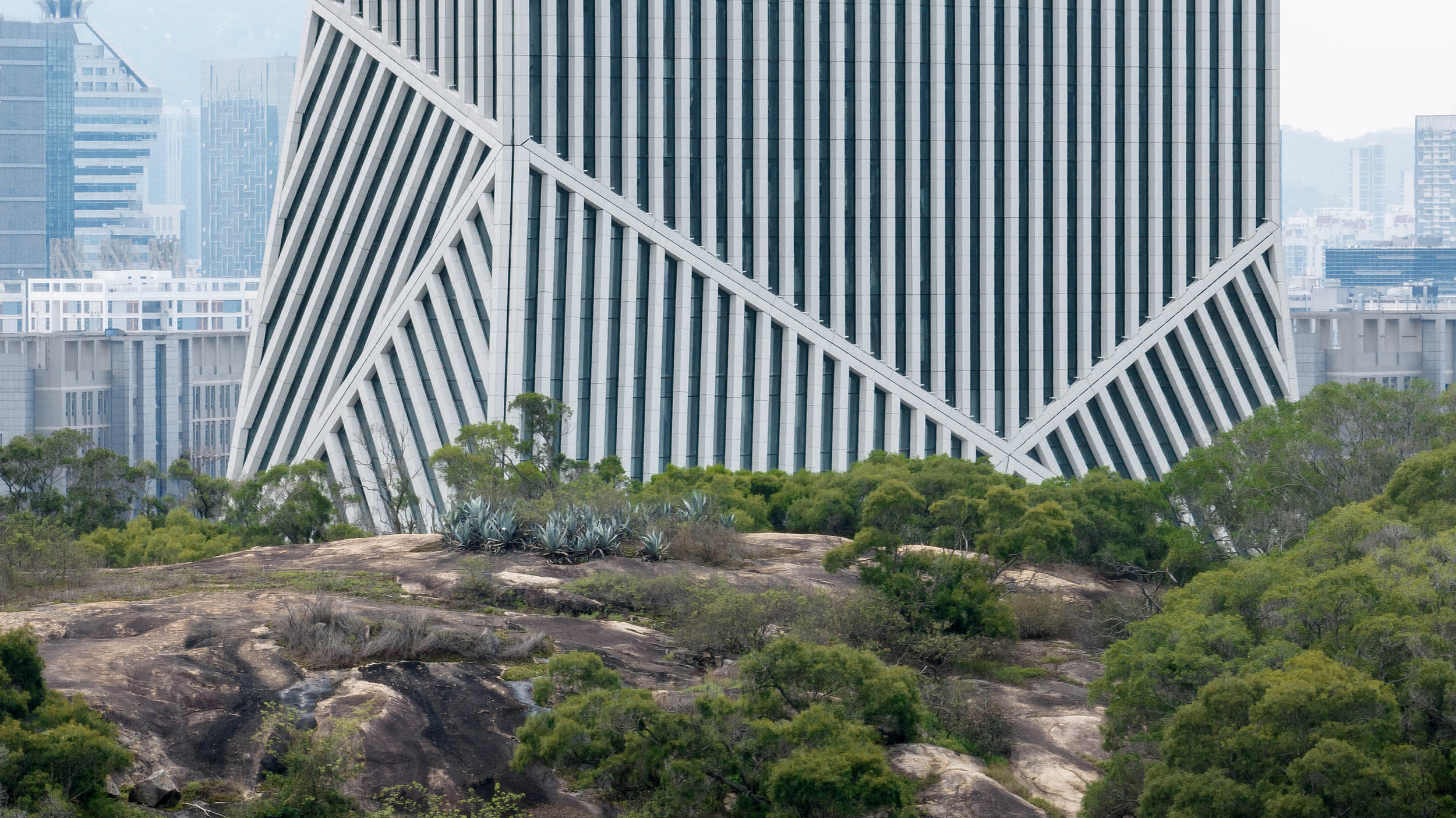 OMA’s JOMOO Headquarters flexes white ceramic stripes angled in different directions