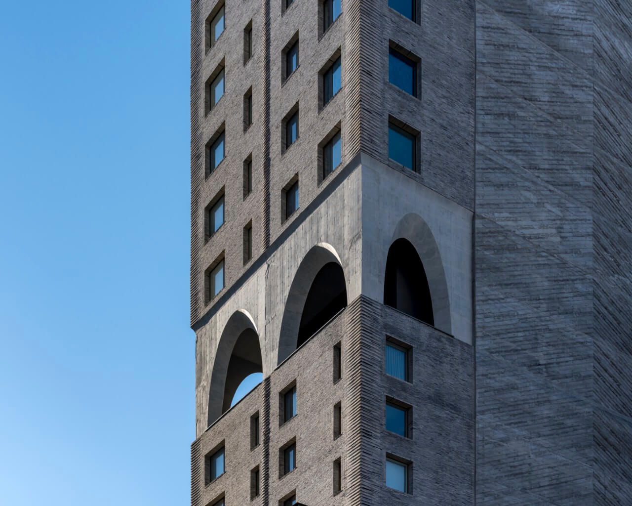 a corner shot showing the two story poured concrete arches at the mechanical, or "skyview", level and the north herringbone concrete wall